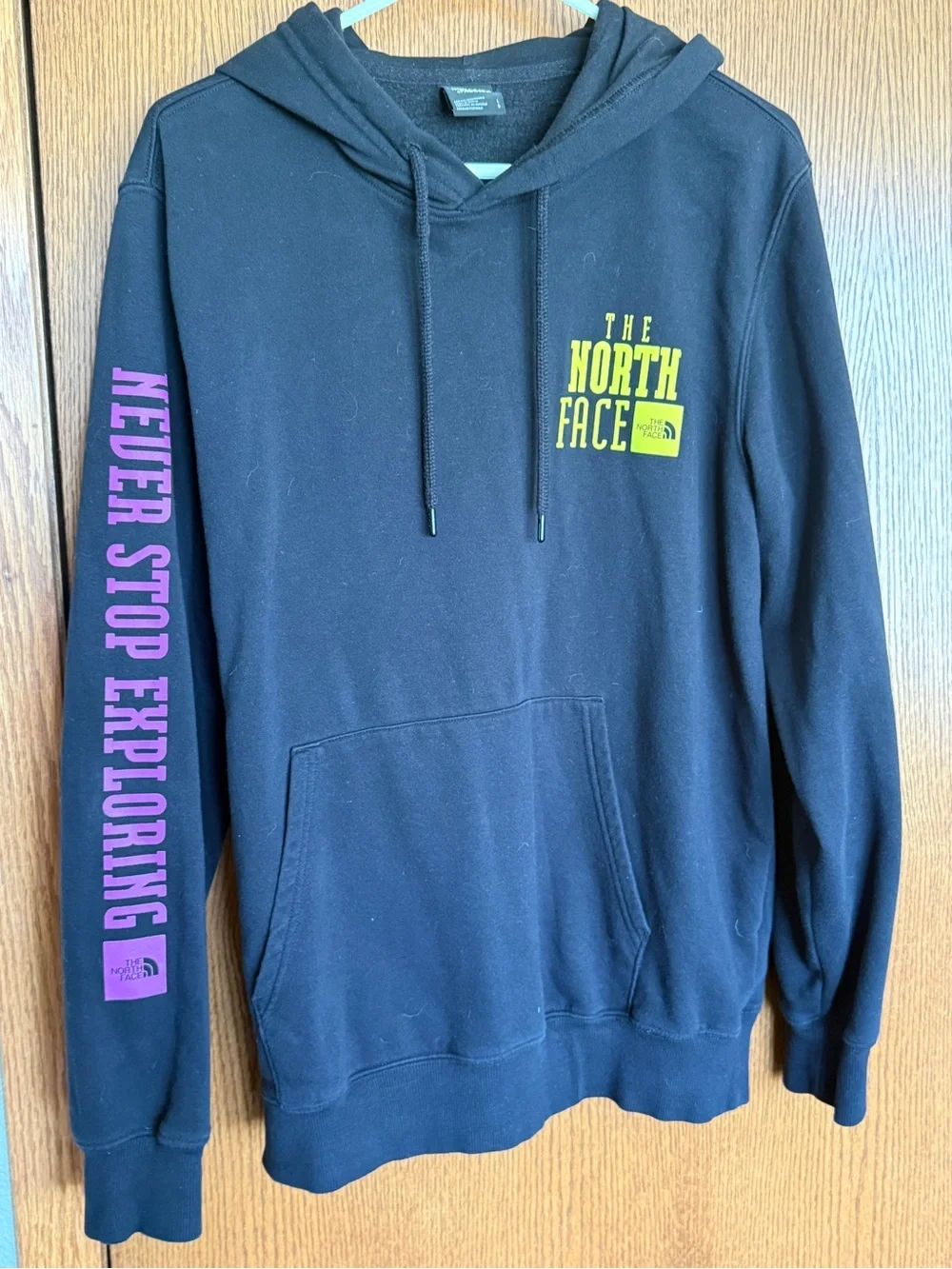 The North Face Black Hoodie with Yellow Chest Logo and Pink Sleeve Text